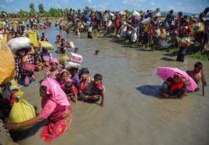 Rohingya people fleeing persecution, crossing a river